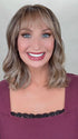 Kim Hammon @letstalkwithkim wearing HEPBURN by BELLE TRESS in color BROWN SUGAR BLONDE-R | A warm, dimensional blend of medium brown and golden blonde highlights with natural-looking darker roots for depth and a sun-kissed finish.
