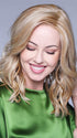 The loose waves and curtain bangs create an enchanting hairstyle