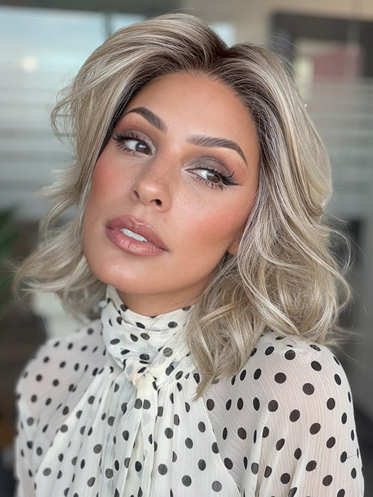 Model is wearing LORYN in color SEA  SALT BLOND R | A perfect mixture of cool, icy-blond and warm-dark blond. The rich brown root tone enhances the modern appearance