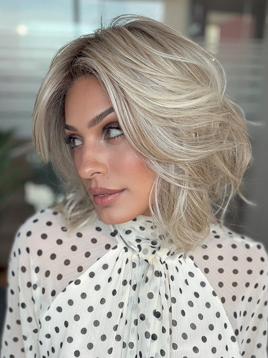Model is wearing LORYN in color SEA SALT BLOND R | A perfect mixture of cool, icy-blond and warm-dark blond. The rich brown root tone enhances the modern appearance
