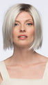 Model is wearing LUMI by Estetica in color SILVERSUN/RT8 | Iced Blonde with Soft Sand and Golden Brown Roots