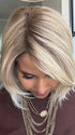 Lorena C. @faux.hurr.lifee wearing MADISON by BELLE TRESS in color CRUSHED ALMOND BLONDE R | A soft Neutral Light Blonde with a Light and Medium Blended Root Color