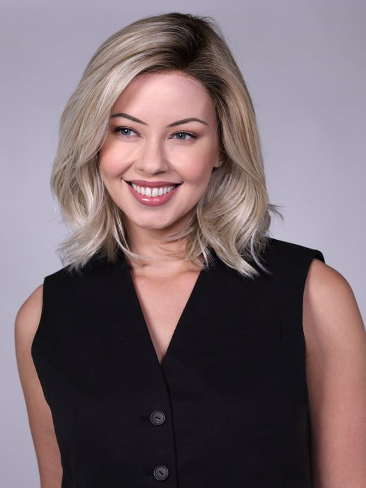 Model is wearing MANHATTAN by BELLETRESS in color CRUSHED-ALMOND-BLONDE-R | A soft Neutral Light Blonde with a Light and Medium Blended Root Color