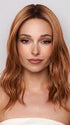 Model is wearing MAUDE by Amore in color RUSTY-SUNRISE-R | Dark brown roots transition into a deep auburn tone with light copper blonde highlights for depth and dimension.
