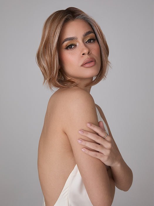 Model is wearing MIRA by AMORE in color CINNAMON FROST R | Warm, medium coppery-brown base with white-blond highlights. The medium brown root color adds a realistic vibe.   