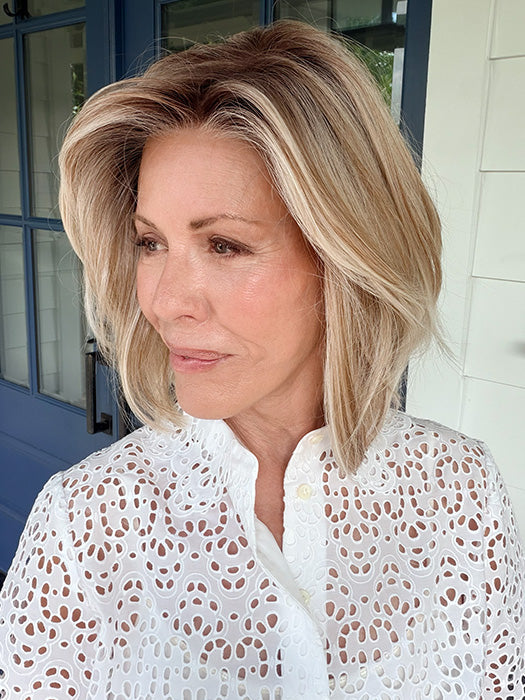 Shannon @shannonwigsout is wearing MIRA by AMORE in color SEA SALT BLOND R | A perfect mixture of cool, icy-blond and warm-dark blond. The rich brown root tone enhances the modern appearance.
