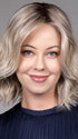 Model is wearing OLIVIA in color BUTTERBEER R | Dark Brown Base and Root that transitions smoothly into a buttery blonde, infused with creamy honey and toffee tones