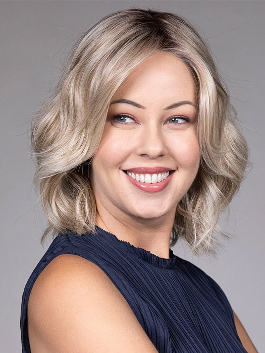 Model is wearing OLIVIA in color BUTTERBEER R | Dark Brown Base and Root that transitions smoothly into a buttery blonde, infused with creamy honey and toffee tones