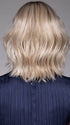 Model is wearing OLIVIA in color BUTTERBEER R | Dark Brown Base and Root that transitions smoothly into a buttery blonde, infused with creamy honey and toffee tones