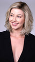 Model is wearing PARK AVE By BELLETRESS in CRUSHED-ALMOND-BLONDE-R | A Soft Neutral Light Blonde with a Light and Medium Blended Root Color