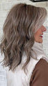 Marcie @wig.obsessed wearing BEACH WAVE MAGIC by TRESSALLURE in color 52/38/49/R8 | 3 Tones of Grey blended with Dark Brown Roots
