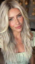 Madeline wearing ROXIE by RENE OF PARIS in BILLIONAIRE-BLOND | A chic, sophisticated shade with a rich mocha root melting into beige, ash, and cream blond tones. Face-framing cream and white blond highlights add a refined, upscale finish.