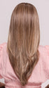 Roxie wearing KATNISS by BELLETRESS in BROWN SUGAR BLONDE-R | A warm, dimensional blend of medium brown and golden blonde highlights with natural-looking darker roots for depth and a sun-kissed finish.