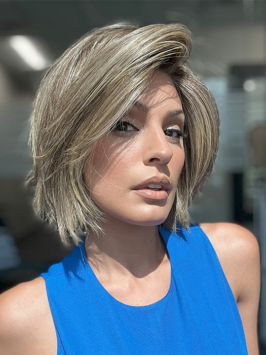 Model is wearing READY by ELLEN WILLE in color BERNSTEIN ROOTED 12.24.27 | Light Brown base with subtle Light Honey Blonde and Light Butterscotch Blonde highlights and Dark Roots