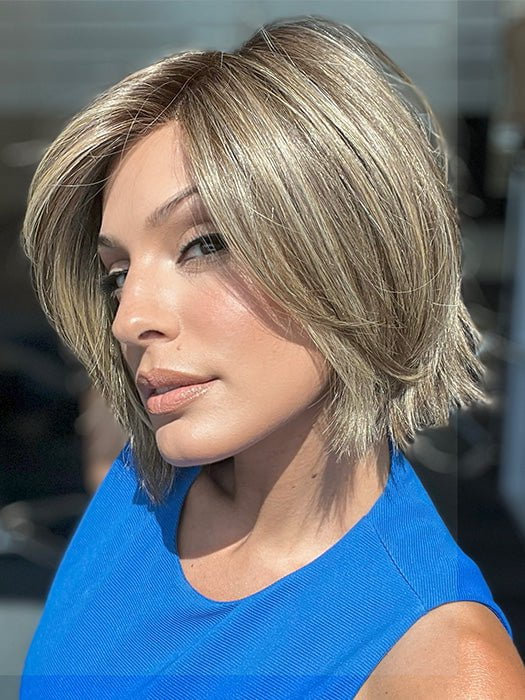 Model is wearing READY by ELLEN WILLE in color BERNSTEIN ROOTED 12.24.27 | Light Brown base with subtle Light Honey Blonde and Light Butterscotch Blonde highlights and Dark Roots