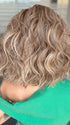 Model is wearing ROMANTIC RENAISSANCE by RAQUEL WELCH in color SS12/22 SHADED CAPPUCCINO | Light Golden Brown Evenly Blended with Cool Platinum Blonde Highlights and Dark Roots