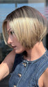 Model is wearing SHELBY by JON RENAU in color 24BT18S8 SHADED MOCHA | Medium Natural Ash Blonde & Light Natural Gold Blonde Blend, Shaded with Medium Brown