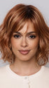 Model is wearing Terra by Amore in color  RUSTY-SUNRISE-R | Dark brown roots transition into a deep auburn tone with light copper blonde highlights for depth and dimension.