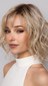 Model is wearing Terra by Amore in color SEA SALT BLOND R | A perfect mixture of cool, icy-blond and warm-dark blond. The rich brown root tone enhances the modern appearance