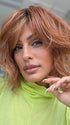 Model is wearing TERRA by AMORE in color RUSTY-SUNRISE-R | Dark brown roots transition into a deep auburn tone with light copper blonde highlights for depth and dimension.
