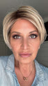Emily H. @she_sheds_more wearing SAN FRANCISCO by BELLETRESS in color BEIGE LINEN BLONDE R | Neutral Beige Blonde mixed with Medium and Dark Blonde, Highlighted using Ash Blonde with Medium Brown Root color