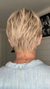 Emily H. @she_sheds_more wearing SAN FRANCISCO by BELLETRESS in color BEIGE LINEN BLONDE R | Neutral Beige Blonde mixed with Medium and Dark Blonde, Highlighted using Ash Blonde with Medium Brown Root color