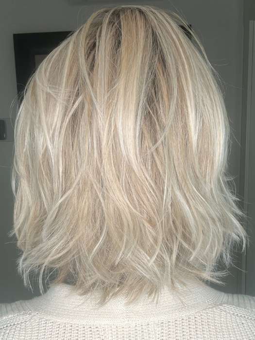 Emily H. @she_sheds_more wearing Alicante by BelleTress in shade CRUSHED ALMOND BLONDE R | A soft Neutral Light Blonde with a Light and Medium Blended Root Color.