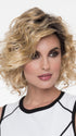 A long, side-swept bang and artfully messy curls