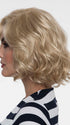 Coco's artfully curled layers add a touch of flirty sophistication