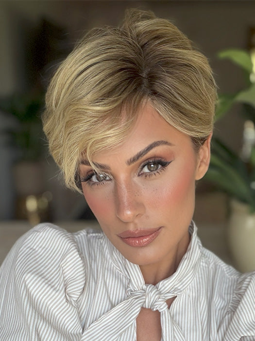 Roxie is wearing DEMI by JON RENAU in color 12FS8 SHADED PRALINE | Medium Natural Gold Blonde, Light Gold Blonde, Pale Natural Blonde Blend, Shaded with Dark Brown