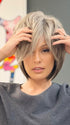 Roxie wearing REESE by NORIKO in SANDY SILVER | Medium Brown Transitionally Blending to Silver and Dramatic Silver Bangs