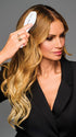 Model is wearing 19IN WAVY INVISIBLE EXTENSION by HAIRDO in color SS14/88H SHADED GOLDEN WHEAT | Dark Blonde Evenly Blended with Pale Blonde Highlights and Dark Roots