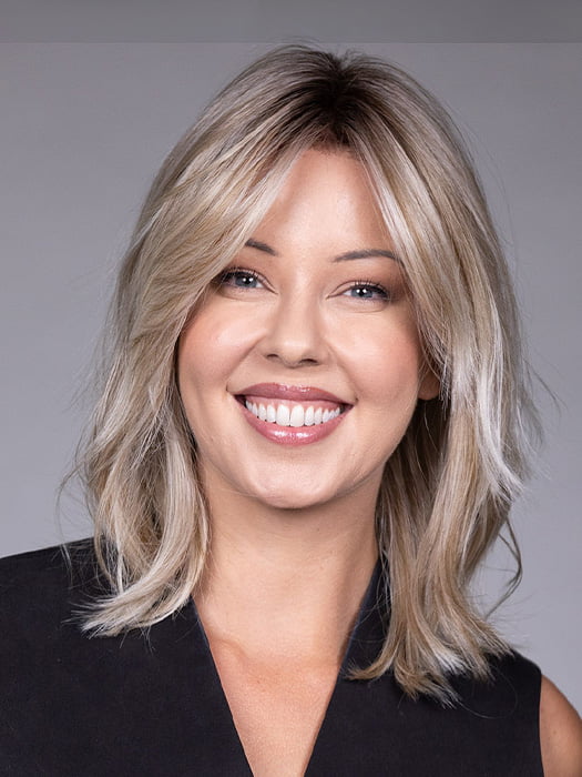 Model is wearing MONACO by BELLETRESS in color MILKSHAKE BLONDE R | A mixture of Light Sandy Brown, Highlighted with Light Ash Blonde with a Hint of Light Platinum Blonde with a Medium Root Color