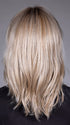 Model is wearing MONACO by BELLETRESS in color MILKSHAKE BLONDE R | A mixture of Light Sandy Brown, Highlighted with Light Ash Blonde with a Hint of Light Platinum Blonde with a Medium Root Color