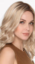 Model is wearing MOLLY by ENVY in SILKY BEIGE | Light Platinum Blonde with Dark Brown Roots
