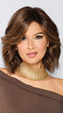 Model is wearing STEAL THE SHOW by RAQUEL WELCH in color SS8/29 SHADED HAZELNUT | Rich Medium Brown Evenly Blended with Ginger Blonde Highlights with Dark Roots