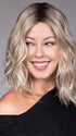 Model is wearing ANDIE in color BUTTER BEER R | A rich blend of warm brunette and golden honey highlights finished with a soft, natural root.