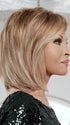 This classic collar-length wig features all-over soft layers that blend seamlessly into a side swept bang | Color R29S+ Glazed Strawberry