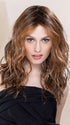 Model is wearing SERENA in BAHAMA BEIGE | Medium Honey Blonde, Light Ash Blonde, and Lightest Reddish Brown blend